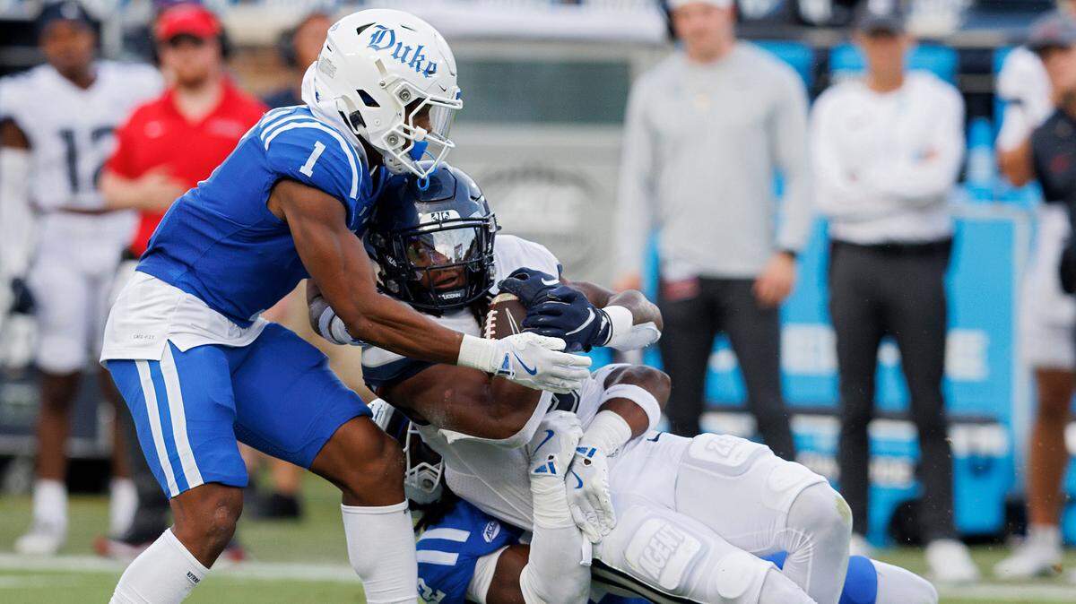 Duke’s Terry Moore and Tre Freeman tackle Connecticut’s Cam Edwards during the first half of the Blue Devils’ game against UConn on Saturday, Sept. 14, 2024, at Wallace Wade Stadium in Durham, N.C.