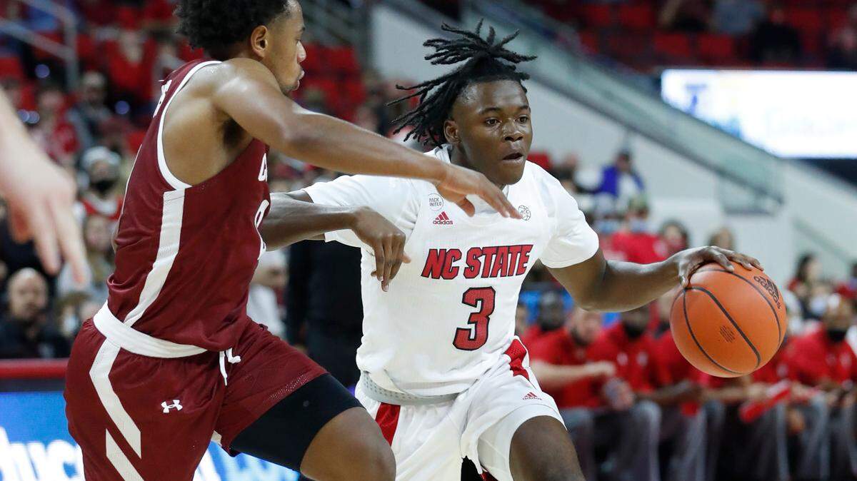 N.C. State’s Cam Hayes (3) drives around Colgate’s Nelly Cummings (0) during the first half of N.C. State’s game against Colgate at PNC Arena in Raleigh, N.C., Saturday, November 13, 2021.