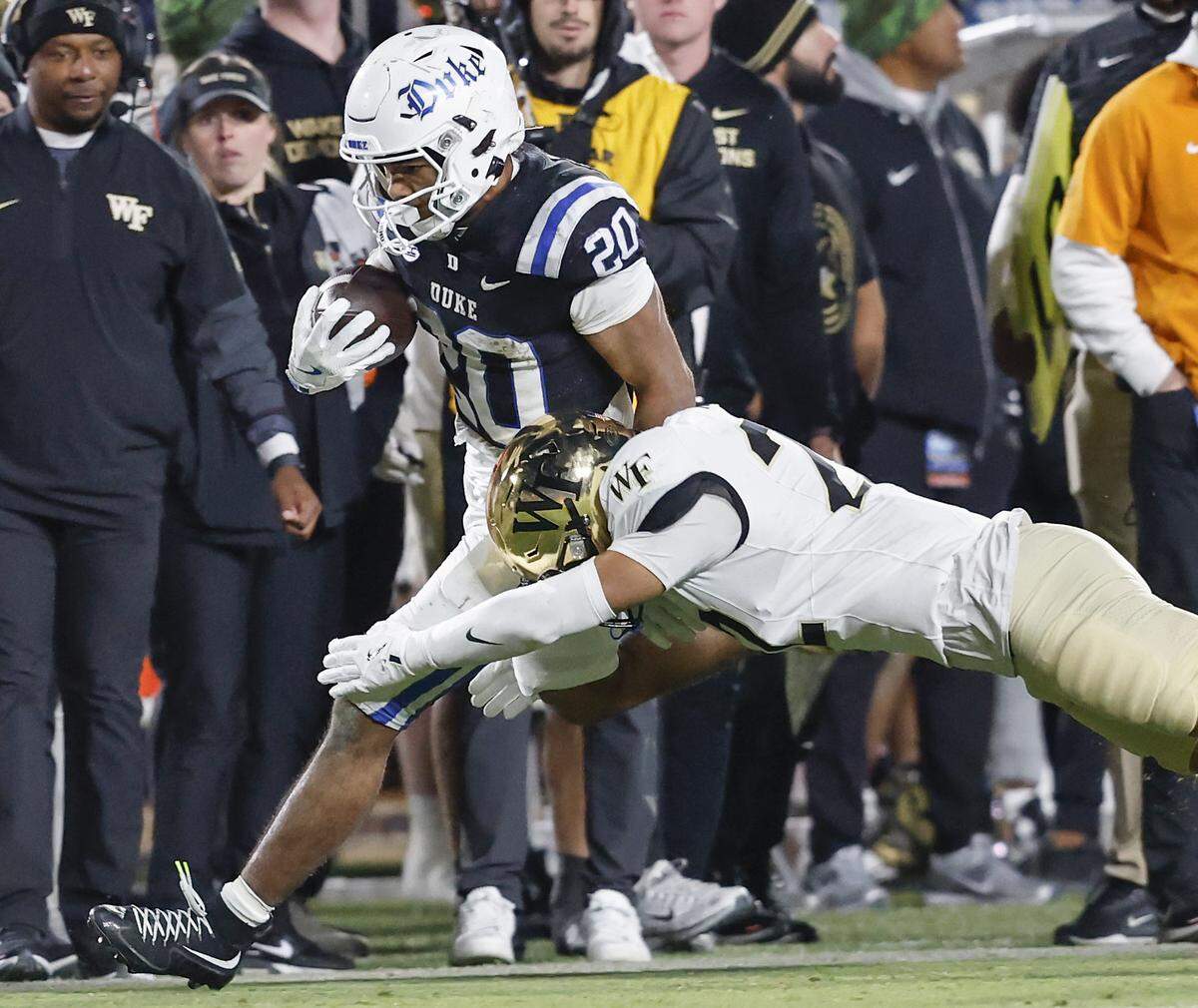 Duke’s Nate Sheppard runs the ball past Wake Forest’s Myles Turpin during the second half of the Blue Devils’ 49-32 win on Saturday, Nov. 29, 2025, at Wallace Wade Stadium in Durham, N.C.