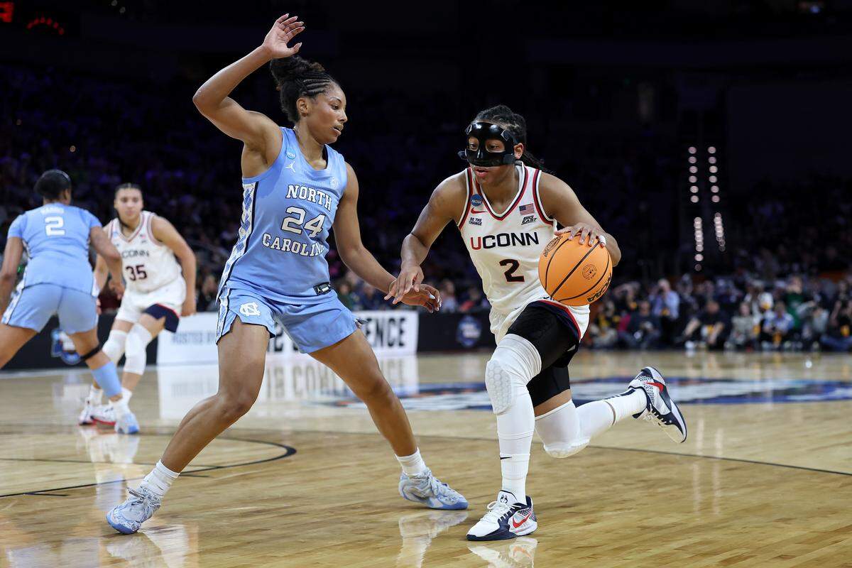 KK Arnold (2) of the UConn Huskies dribbles the ball while defended by Indya Nivar of the North Carolina Tar Heels during the second quarter of the teams’ NCAA Women’s Basketball Tournament Sweet 16 game at Dickies Arena on March 27, 2026 in Fort Worth, Texas.