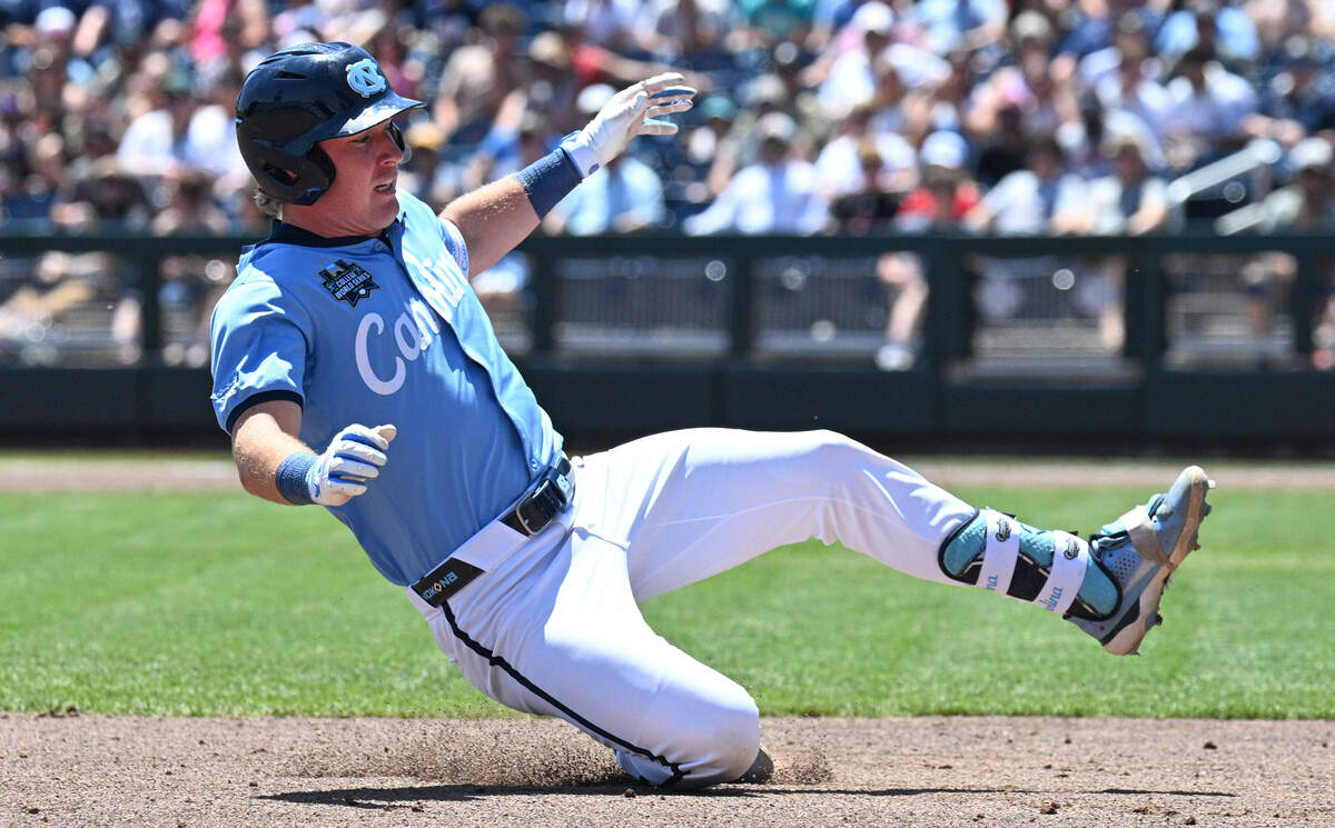 North Carolina Tar Heels third baseman Cooper Nicholson (1) slides into third base on a triple against the West Virginia Mountaineers during the third inning at Charles Schwab Field.