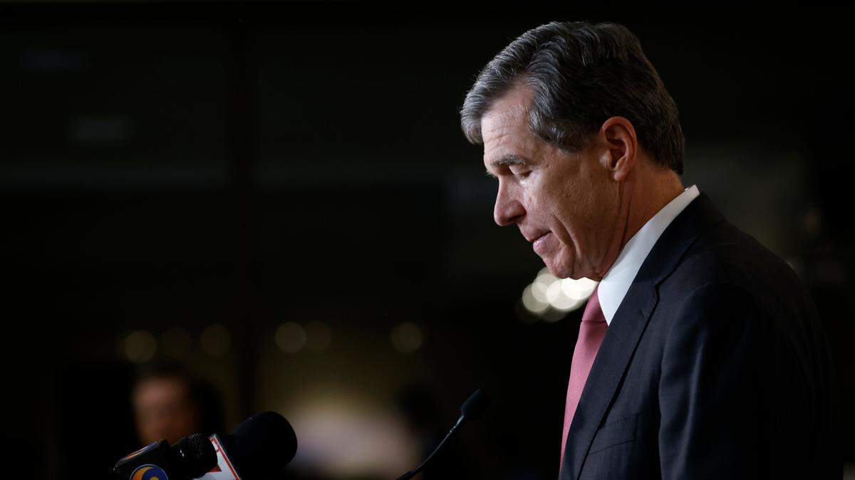 North Carolina Gov. Roy Cooper speaks at a press briefing following a shooting that left five dead, including an off-duty police officer, on Thursday, Oct. 13, 2022, in Raleigh, N.C.