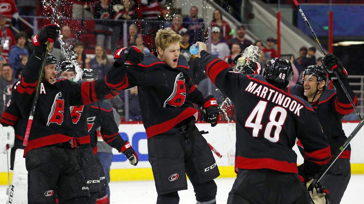 Carolina Hurricanes’ Warren Foegele (13) and teammates celebrate at center ice after a win over the Edmonton Oilers, Friday, Feb. 15, 2019, in Raleigh, N.C. (AP Photo/Karl B DeBlaker)