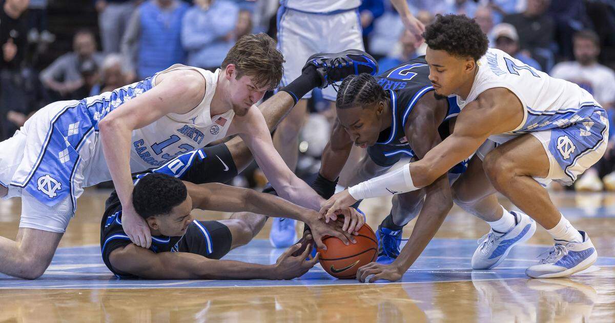 North Carolina center Henri Veesaar (13), Duke guards Caleb Foster (1) and Dame Sarr (7) along with North Carolina guard Seth Trimble (7) fight to secure a loose ball in the second half on Saturday, February 7, 2026 at the Smith Center in Chapel Hill, N.C.