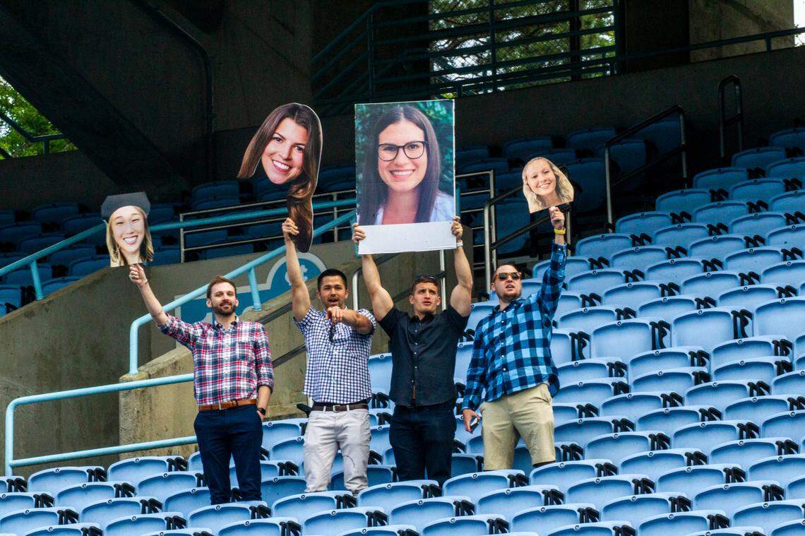 Guests in the stands at Kenan Stadium look for graduates on the field during a commencement ceremony at UNC-Chapel Hill Friday, May 14, 2021.