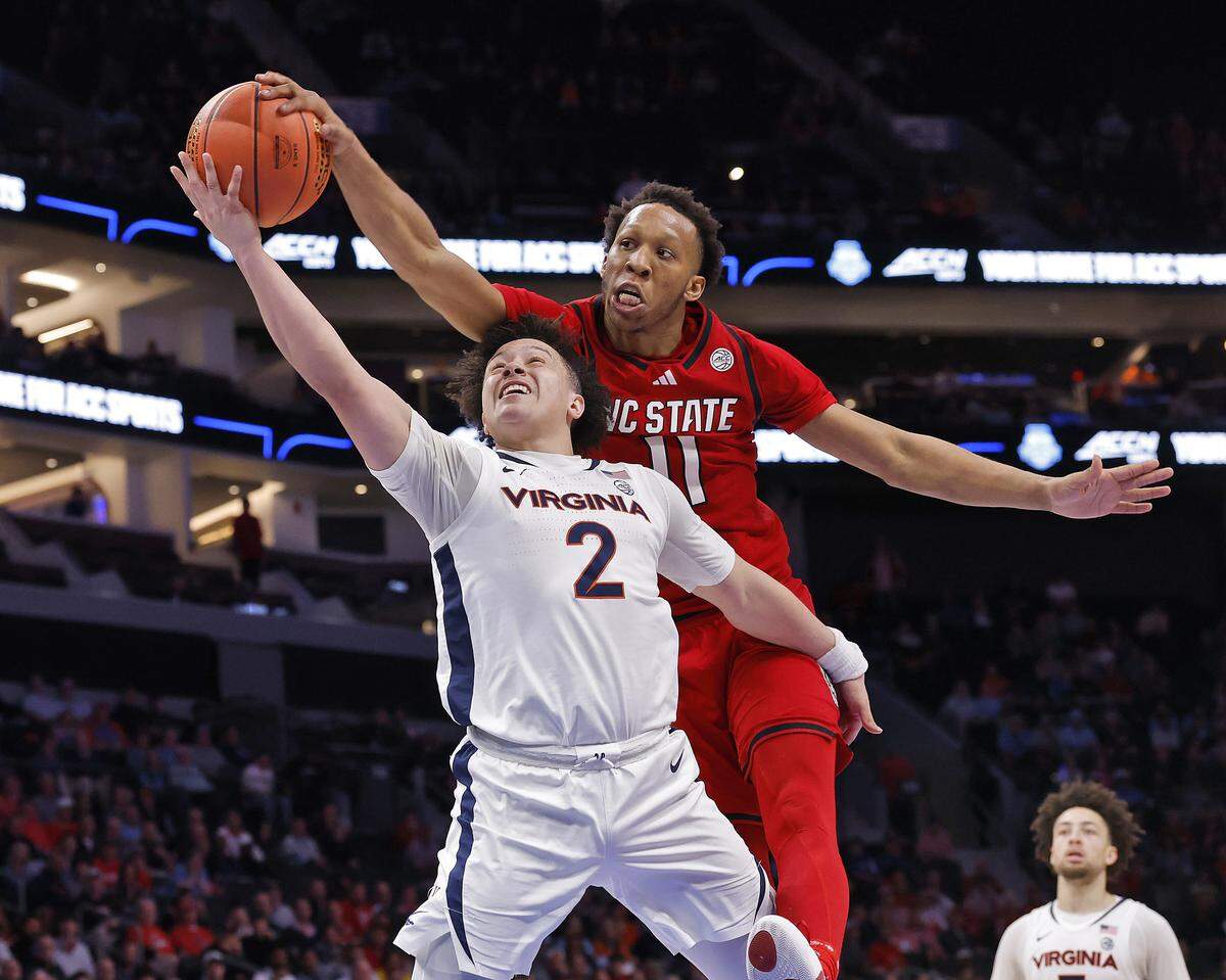 N.C. State's Quadir Copeland blocks a shot by Virginia's Chance Mallory during the second half of the Wolfpack’s 81-74 loss in the ACC Tournament quarterfinals on Thursday, March 12, 2026, at the Spectrum Center in Charlotte, N.C. 