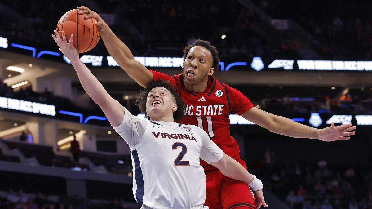 N.C. State's Quadir Copeland blocks a shot by Virginia's Chance Mallory during the second half of the Wolfpack’s 81-74 loss in the ACC Tournament quarterfinals on Thursday, March 12, 2026, at the Spectrum Center in Charlotte, N.C.
