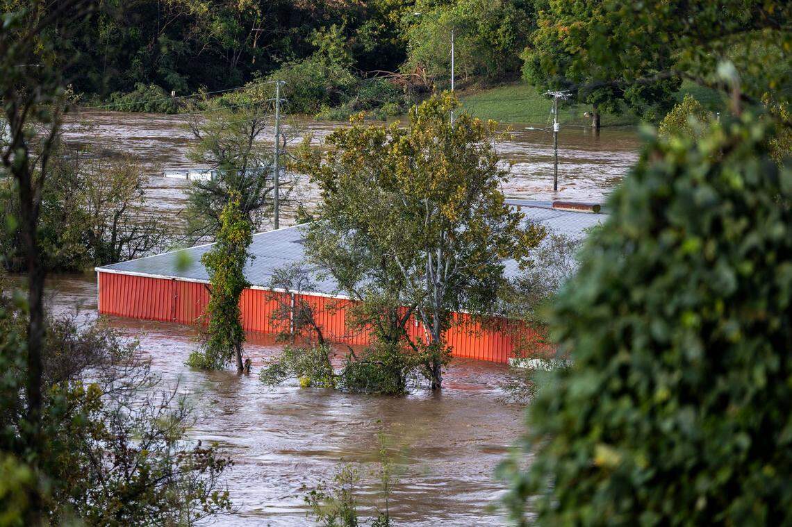 The French Broad River breaks its banks Asheville on Friday, Sept. 27, 2024 as the remnants of Hurricane Helene caused flooding, downed trees, and power outages in western North Carolina.