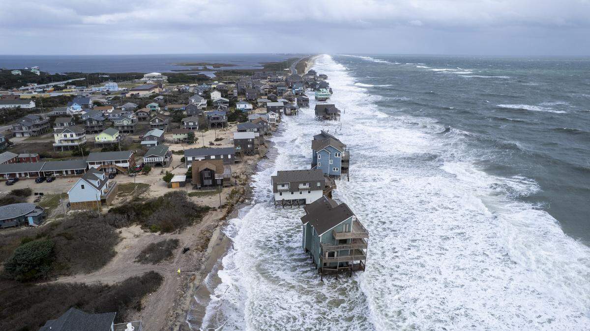 Rough surf threatens beach homes during high tide Friday morning, Oct. 10, 2025, in Buxton as a nor’easter approaches the North Carolina coast. Multiple homes in the community have collapsed into the Atlantic Ocean since mid-September.