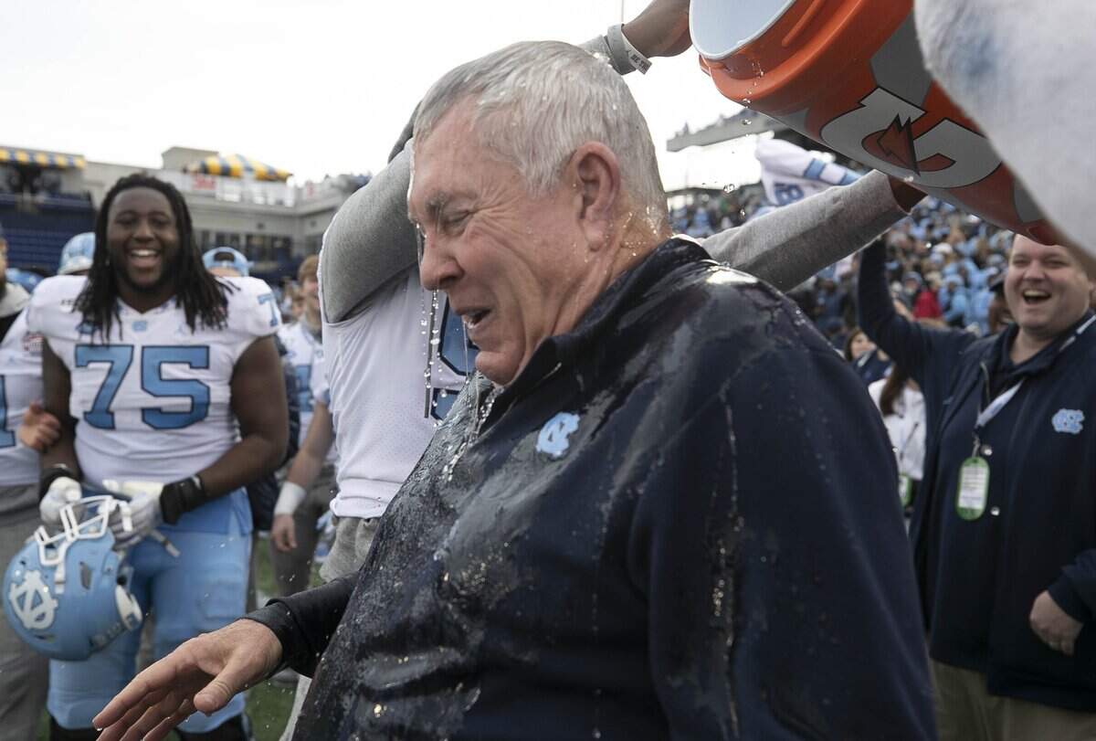 North Carolina players douse coach Mack Brown with water as they celebrate the Tar Heels’ 55-13 victory over Temple in the Military Bowl on Friday, December 27, 2019 at Navy-Marine Corps Memorial Stadium in Annapolis, Maryland.