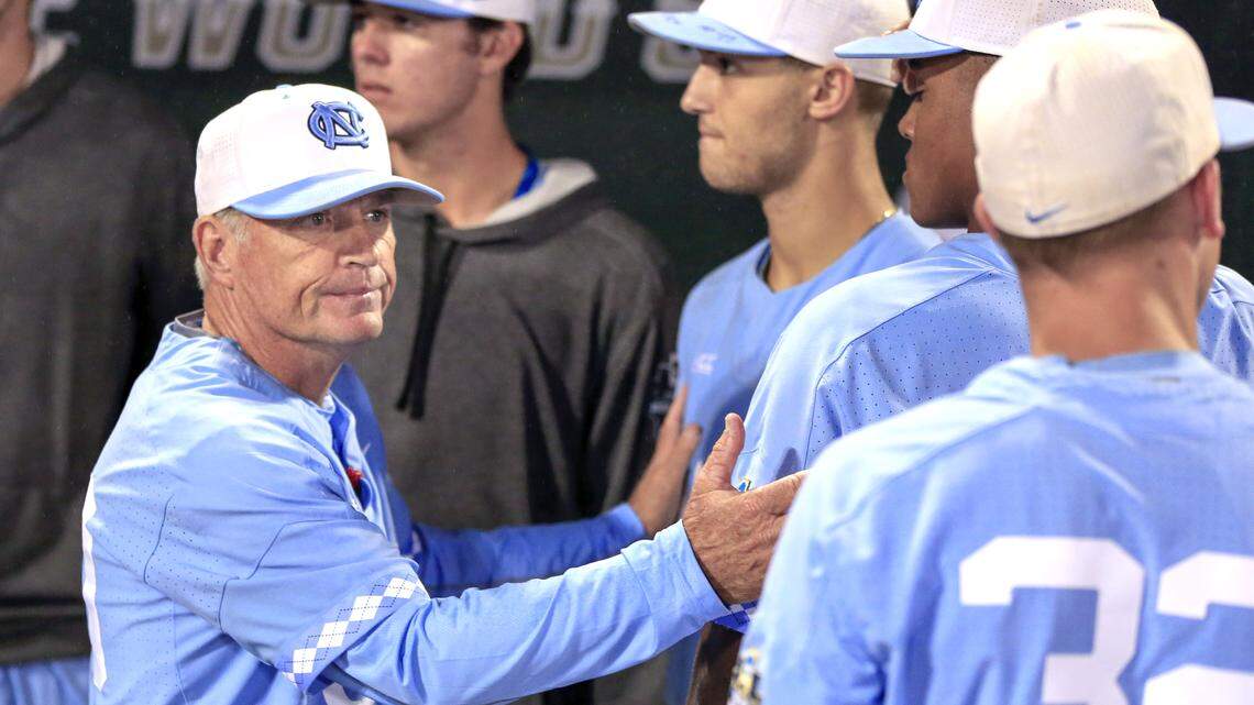 North Carolina coach Mike Fox consoles players following the team's 11-6 loss to Oregon State in an NCAA College World Series baseball elimination game in Omaha, Neb., Wednesday, June 20, 2018.