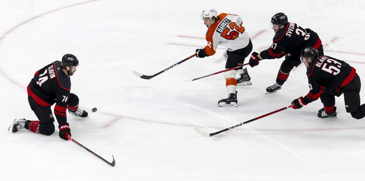 Carolina Hurricanes defenseman Jacoob Slavin (74) block a shot by Philadelphia center (52) Denver Barkey during the overtime period of Game 2 on Monday, May 4, 2026, during the second round of the Stanley Cup Playoffs at Lenovo Center in Raleigh, N.C.