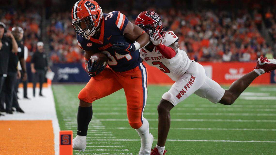 Syracuse running back Sean Tucker (34) is tackled out of bounds by North Carolina State cornerback Aydan White (3) during the first half of an NCAA college football game Saturday, Oct. 15, 2022, in Syracuse, N.Y.