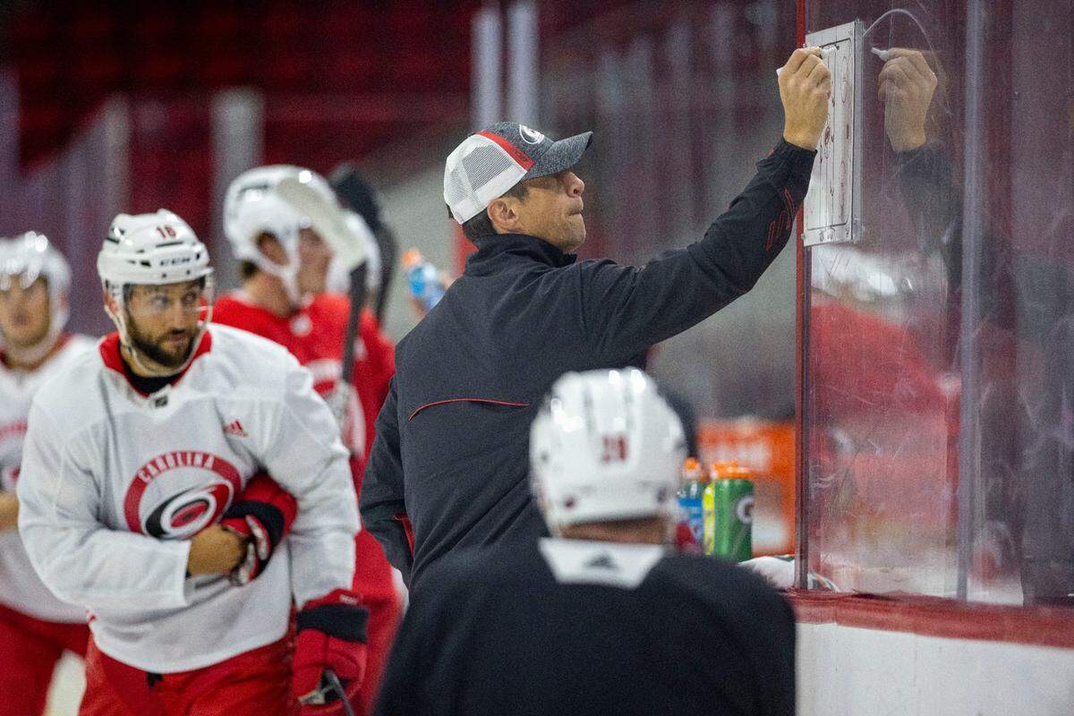 Carolina Hurricanes coach Rod Brind’Amour works with his team during the opening day of training camp on Thursday, September 23, 2021 at PNC Arena in Raleigh, N.C.