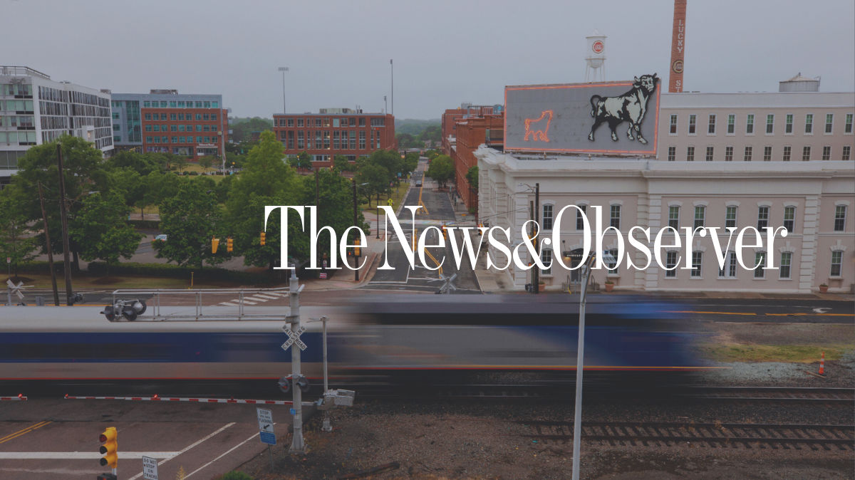 The News & Observer logo over downtown durham bull sign