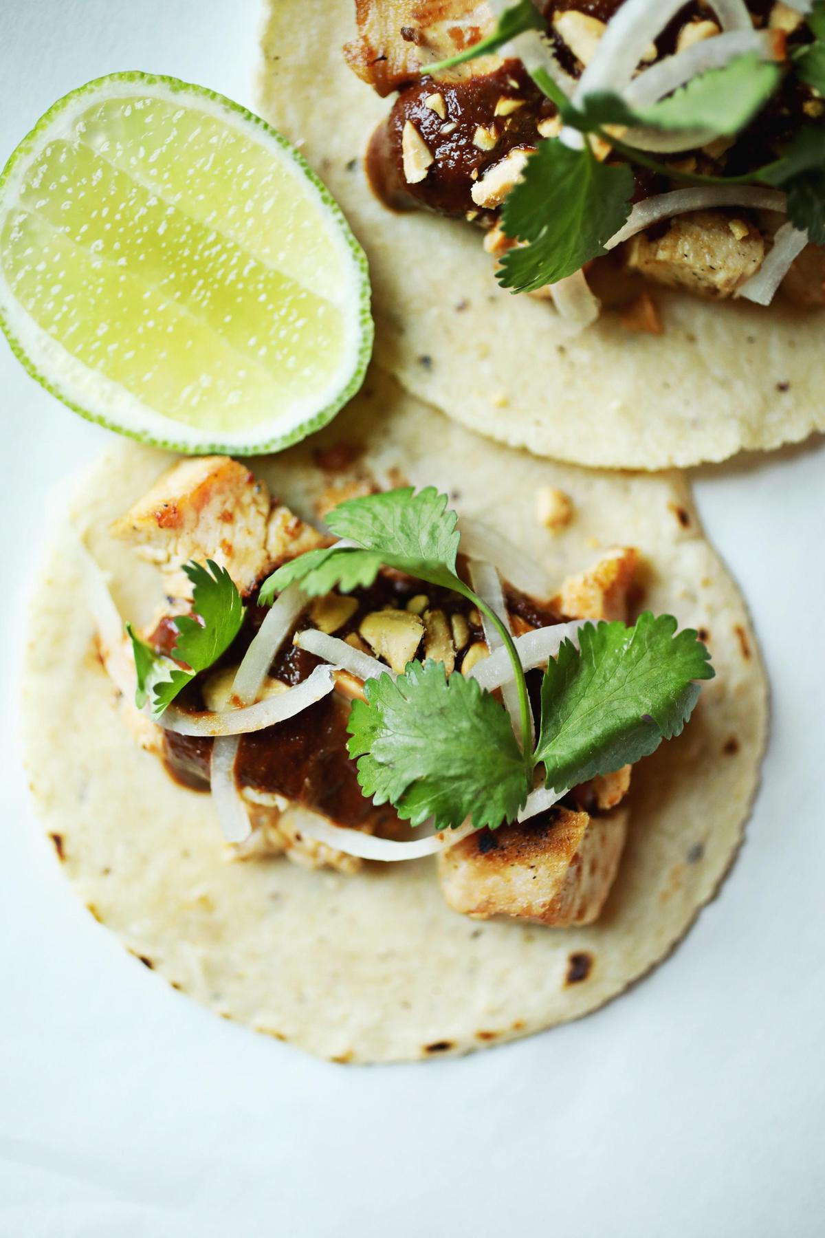 Ex-Voto’s boiled peanut and Cheerwine mole is served with pickled onions, roasted peanuts and cilantro tucked inside handmade tortillas.