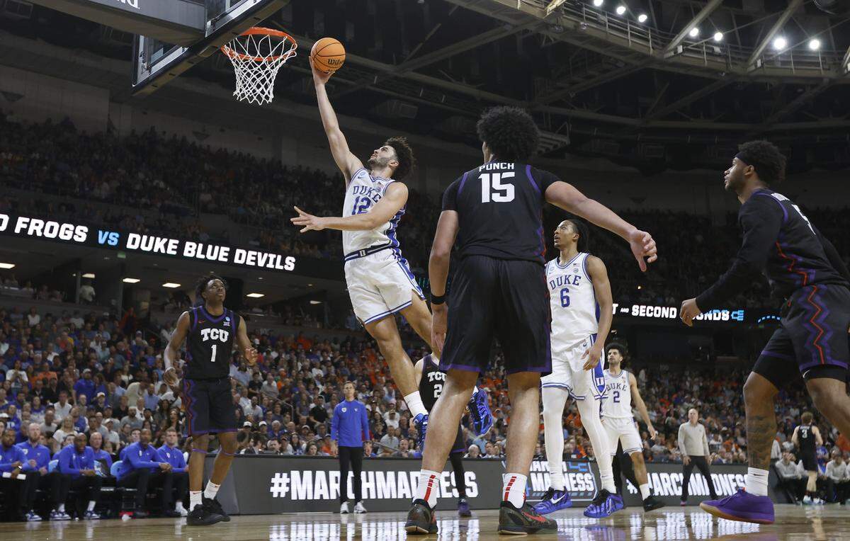 Duke’s Cameron Boozer (12) puts in two during Duke’s 81-58 victory over TCU in the second round of the NCAA Men’s Basketball Tournament at  Bon Secours Wellness Arena in Greenville, S.C., Saturday, March 21, 2026.