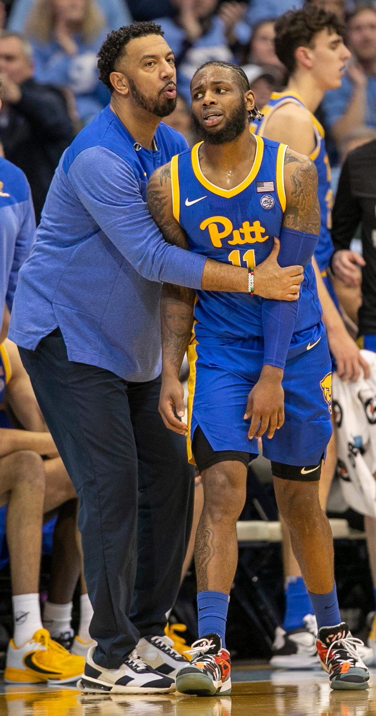 Pittsburgh assistant coach Jason Capel consoles Jamarius Burton (11) after he was called for a foul in the second half against North Carolina on Wednesday, February 1, 2023 at the Smith Center in Chapel Hill, N.C.