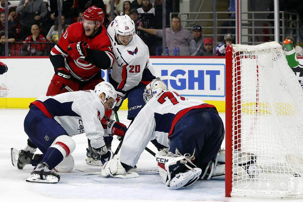 Carolina Hurricanes’ Warren Foegele (13) reacts after finding the puck and getting it past Washington Capitals goaltender Braden Holtby (70), of Switzerland, for a goal during the second period of an NHL hockey game in Raleigh, N.C., Saturday, Dec. 28, 2019. (AP Photo/Karl B DeBlaker)