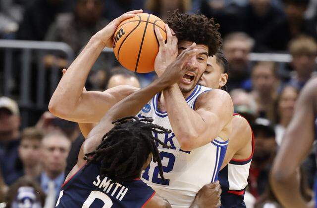 Duke’s Cameron Boozer (12) is defended by UConn's Malachi Smith (0) during the first half of Duke’s game against Connecticut in the NCAA Men’s Tournament East Regional Final at Capital One Arena in Washington, D.C., Sunday, March 29, 2026.