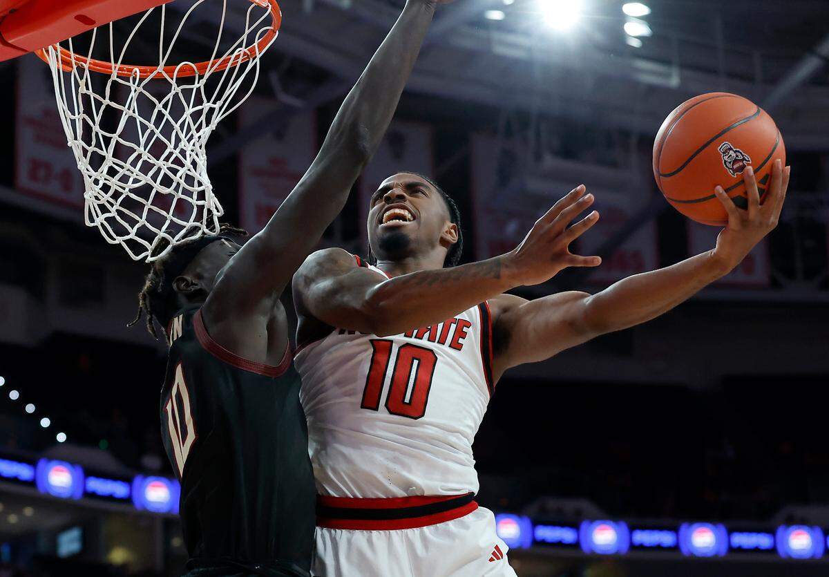 N.C. State’s Marcus Hill drives to the basket against Florida State’s Taylor Bol Bowen during the first half of the Wolfpack’s game on Saturday, Dec. 7, 2024, at Lenovo Center in Raleigh, N.C.