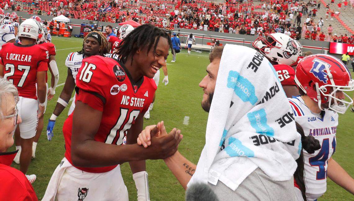 N.C. State quarterback Grayson McCall (2) greets quarterback CJ Bailey (16) after the Wolfpack’s 30-20 victory over LA Tech at Carter-Finley Stadium in Raleigh, N.C., Saturday, Sept. 14, 2024.