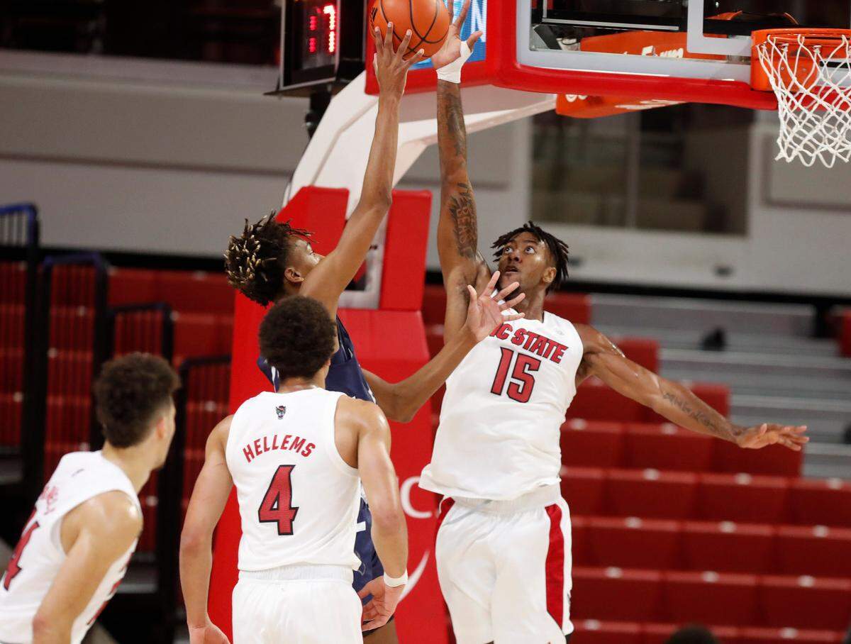 N.C. State’s Manny Bates (15) heads to block a shot by North Florida’s Jadyn Parker (24) during the first half of N.C. State’s game against North Florida in the Mako Medical Wolfpack Invitational at Reynolds Coliseum in Raleigh, N.C., Friday, Nov. 27, 2020.
