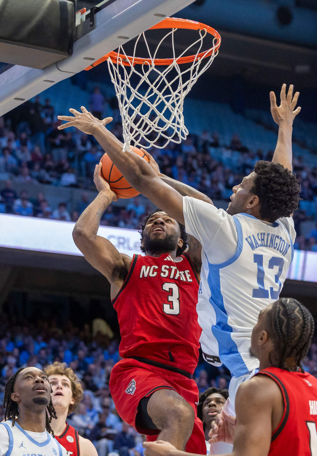North Carolina forward Jalen Washington (13) defends N.C. State’s Dontrez Styles (3) in the first half on Wednesday, February 19, 2025 in Chapel Hill, N.C.