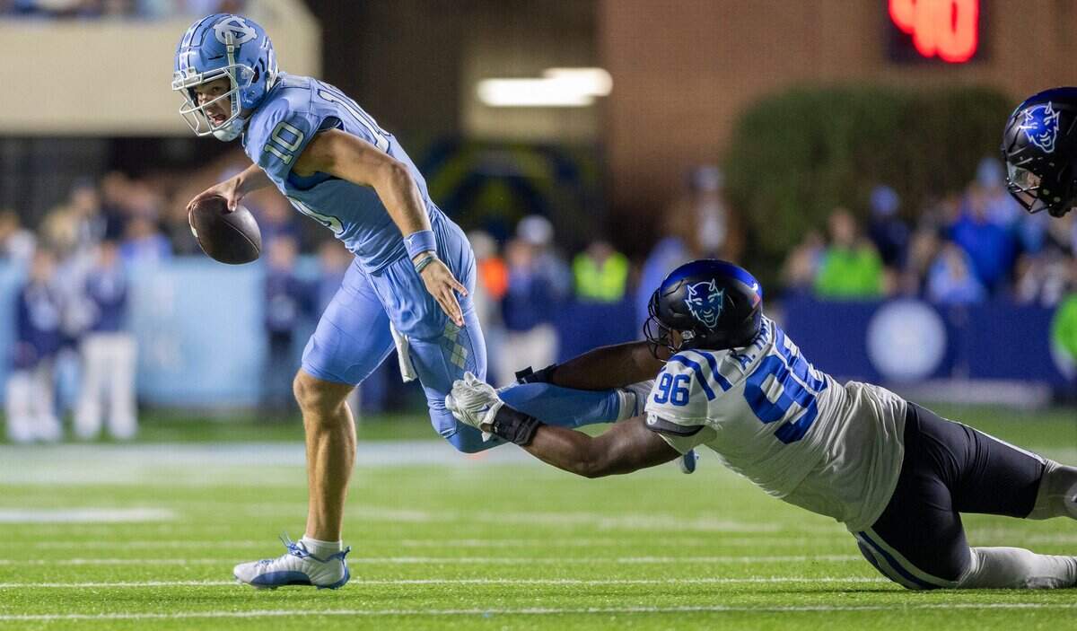Duke’s Aaron Hall (96) works to slow North Carolina quarterback Drake Maye (10) in the second quarter on Saturday, Nov. 11, 2023 at Kenan Stadium in Chapel Hill, N.C.