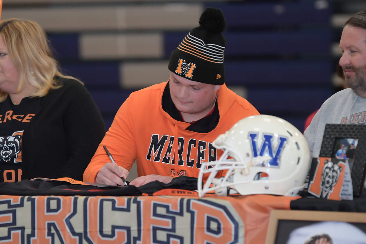 Rolesville High School lineman Gavin Marks signs his letter of intent to play at Mercer University.