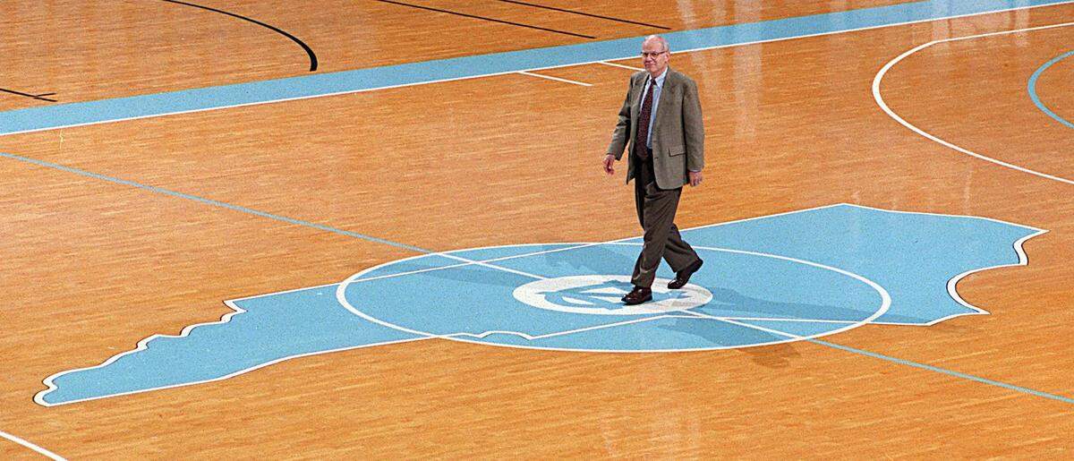 New UNC head basketball coach Bill Guthridge walks across the center of the court in  the Smith Center in 1997.