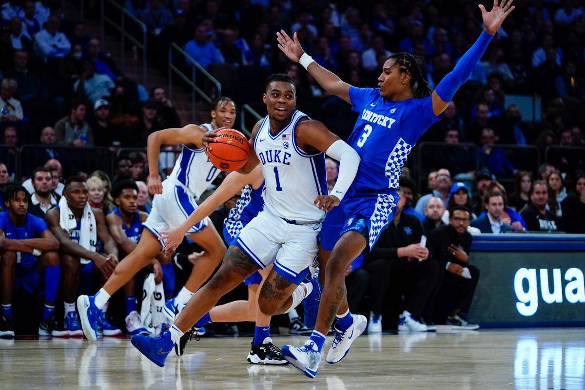 Duke’s Trevor Keels (1) drives past Kentucky’s TyTy Washington (3) during the first half of an NCAA college basketball game Tuesday, Nov. 9, 2021, in New York.