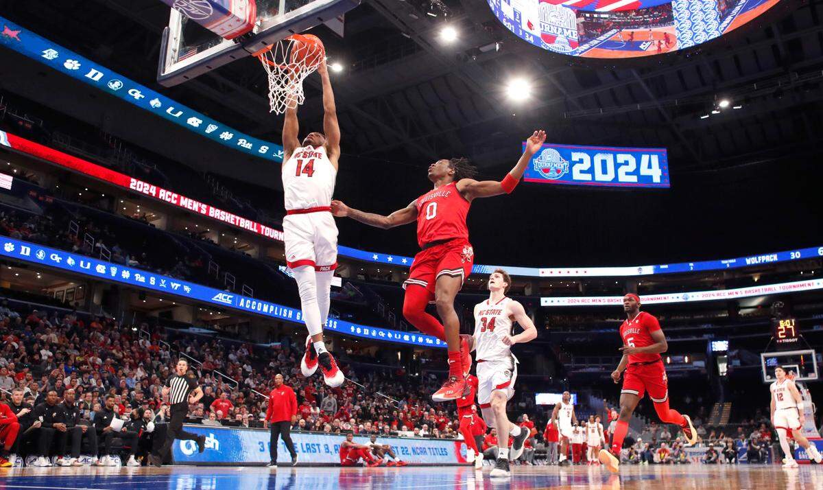 N.C. State’s Casey Morsell (14) slams in two past Louisville’s Mike James (0) during N.C. State’s 94-85 victory over Louisville in the first round of the 2024 ACC Men’s Basketball Tournament at Capital One Arena in Washington, D.C., Tuesday, March 12, 2024.