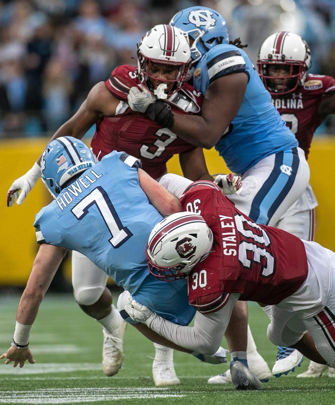 South Carolina’s Damani Staley (30) sacks North Carolina quarterback Sam Howell for a loss of six yards in the fourth quarter during the Duke’s Mayo Bowl on Thursday, December 30, 2021 at Bank of America Stadium in Charlotte, N.C. Howell was sacked four times.