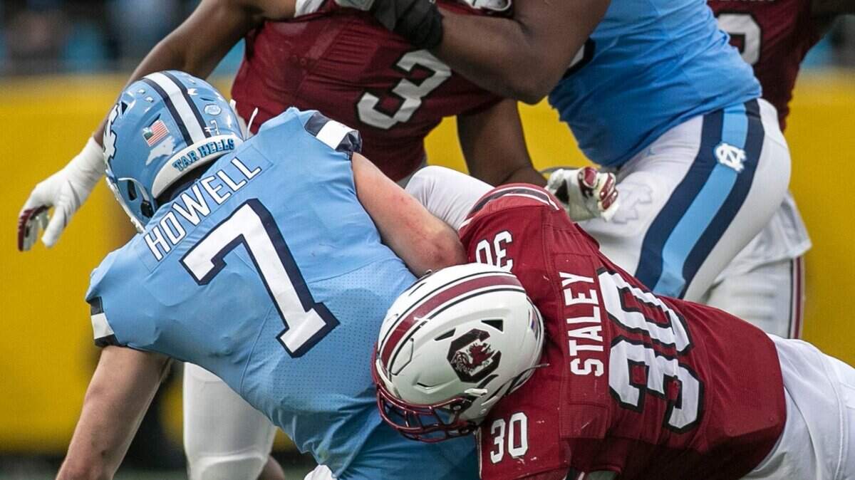 South Carolina’s Damani Staley (30) sacks North Carolina quarterback Sam Howell for a loss of six yards in the fourth quarter during the Duke’s Mayo Bowl on Thursday, December 30, 2021 at Bank of America Stadium in Charlotte, N.C. Howell was sacked four times.