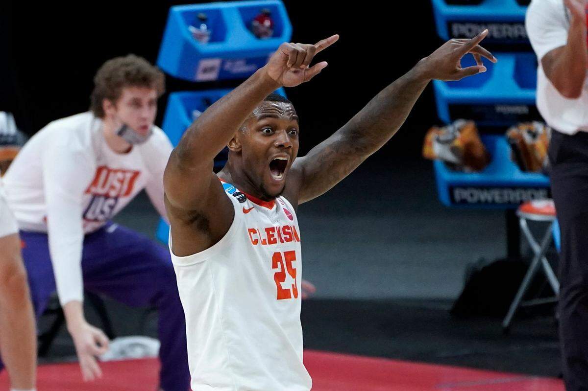 Clemson forward Aamir Simms (25) reacts to a basket against Rutgers during the first half of a men’s college basketball game in the first round of the NCAA tournament at Bankers Life Fieldhouse in Indianapolis, Friday, March 19, 2021. 