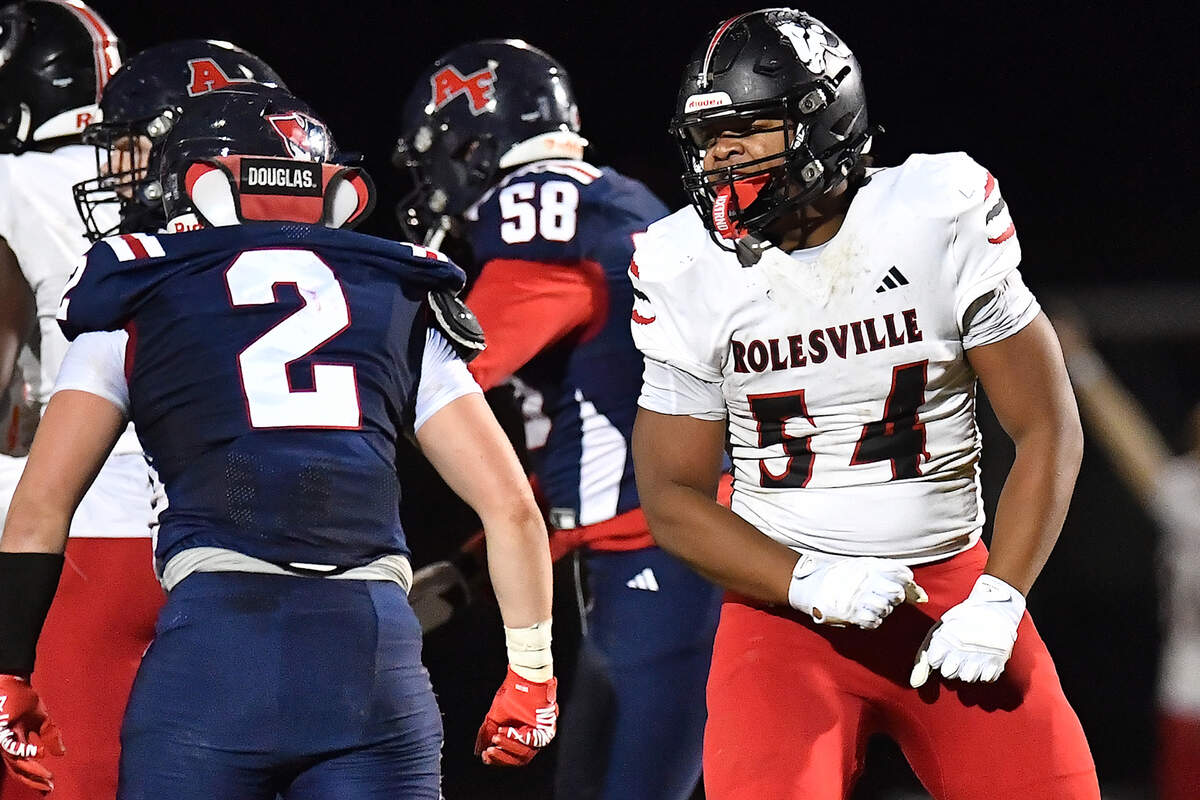 Rolesville defensive lineman Malachi Harris (54) reacts to Apex Friendship's Sam Clodfelter (2) after a play during the first half. The Apex Friendship Patriots and the Rolesville Rams met in the second round of the NCHSAA 8A Playoff game in Apex, N.C. on Nov. 14, 2025.