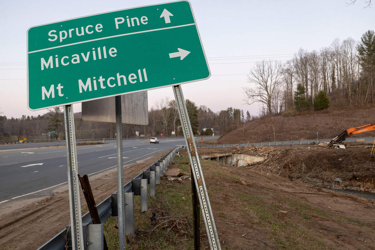 The intersection of US 19E and Micaville Loop Road in Yancey County, N.C. on Tuesday, March 11, 2025. Storm debris from Hurricane Helene, including a large fire suppression water tank, and several vehicles have been cleaned up six months after the storm moved across the region.