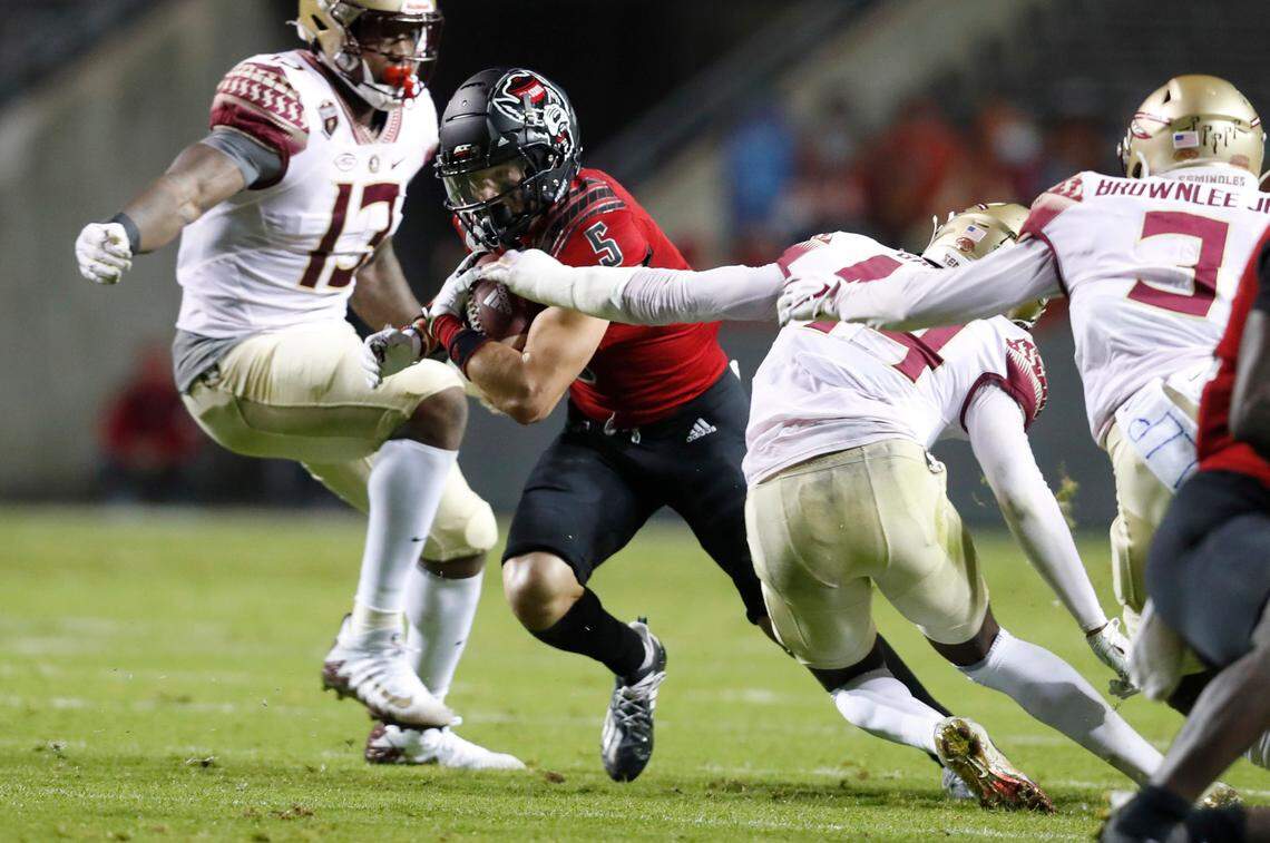 N.C. State wide receiver Thayer Thomas (5) runs by Florida State defensive back Brendan Gant (44) during the first half of N.C. State’s game against Florida State at Carter-Finley Stadium in Raleigh, N.C., Saturday, Nov. 14, 2020.