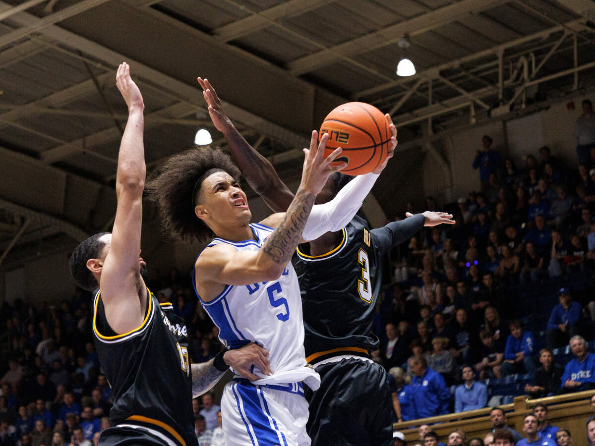 Duke’s Tyrese Proctor drives between La Salle’s Daeshon Shepherd and Anwar Gill during the first half of the Blue Devils’ game on Tuesday, Nov. 21, 2023, at Cameron Indoor Stadium in Durham, N.C.