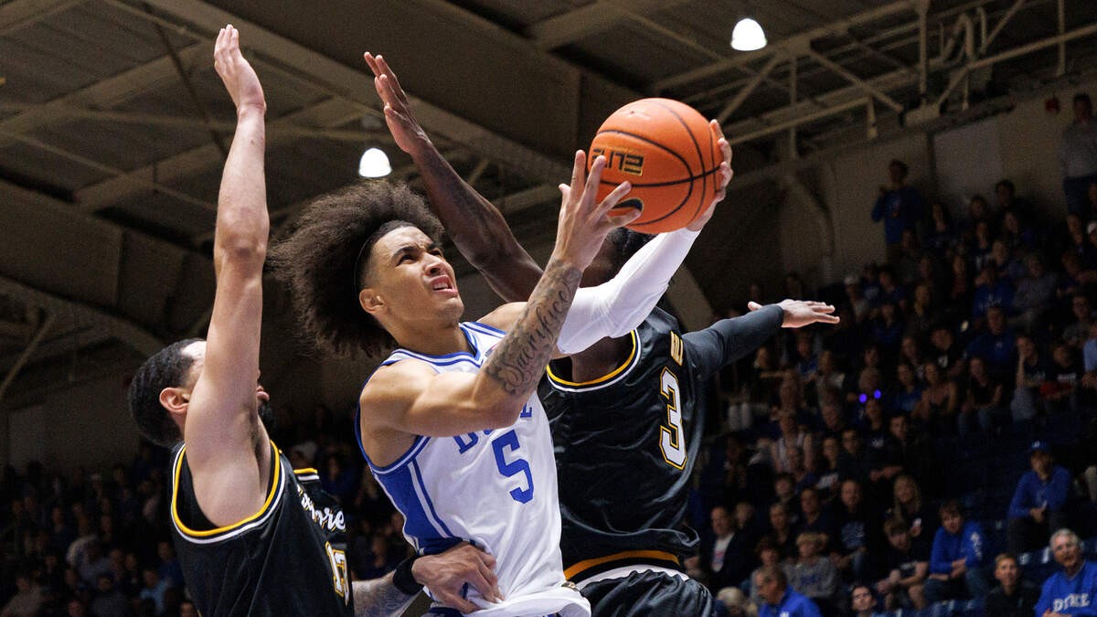 Duke’s Tyrese Proctor drives between La Salle’s Daeshon Shepherd and Anwar Gill during the first half of the Blue Devils’ game on Tuesday, Nov. 21, 2023, at Cameron Indoor Stadium in Durham, N.C.