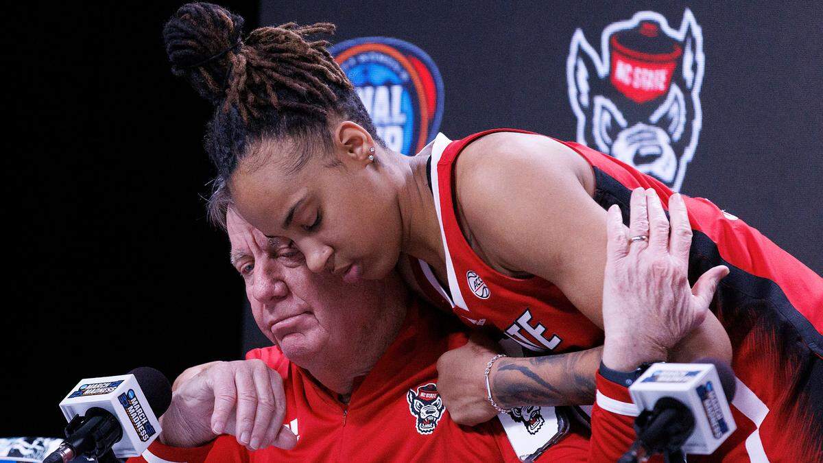 N.C. State’s Aziaha James hugs head coach Wes Moore at the conclusion of a press conference following the Wolfpack’s 78-59 Final Four loss to South Carolina at Rocket Mortgage FieldHouse on Friday, April 5, 2024, in Cleveland, Ohio.
