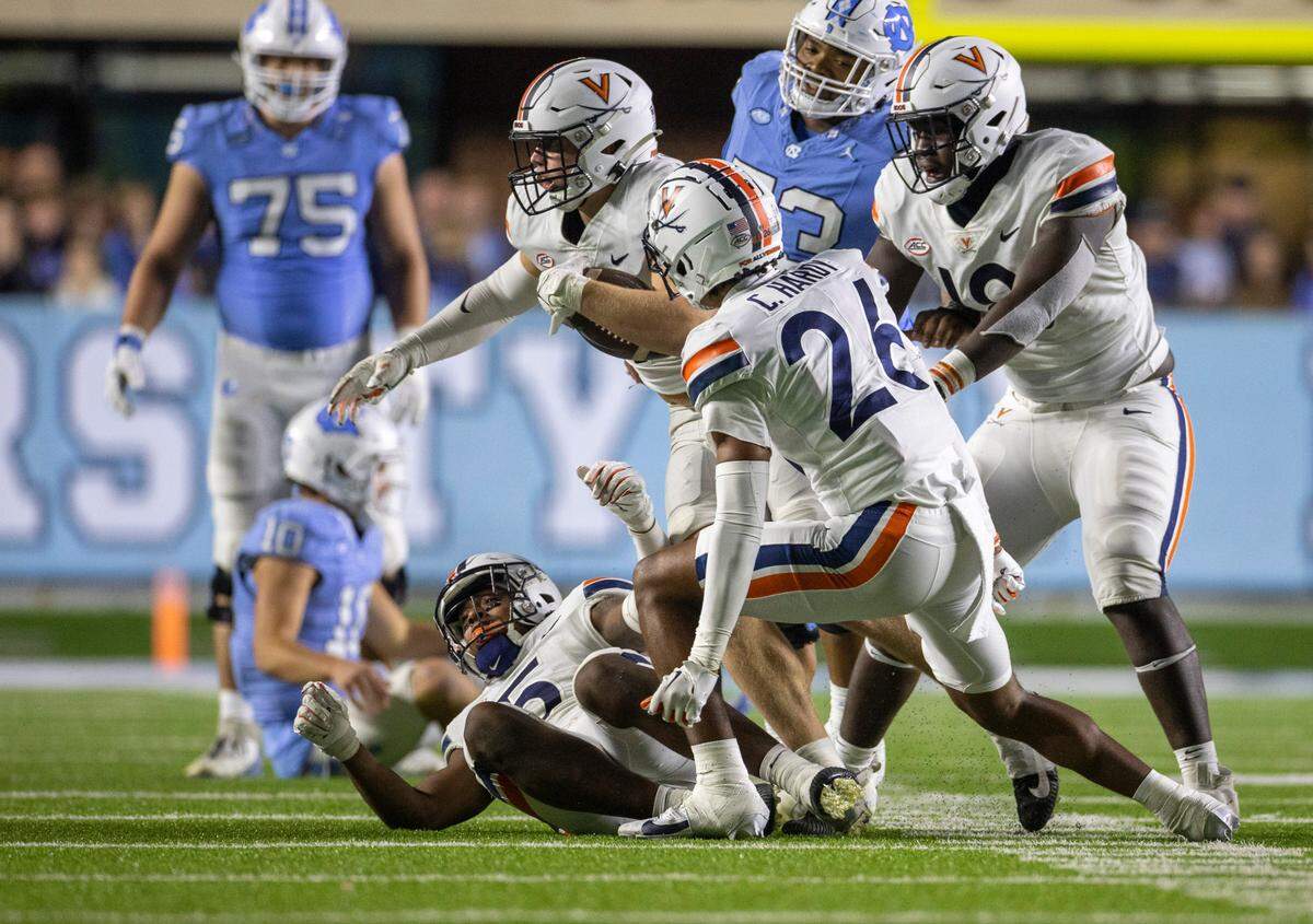 Virginia’s James Jackson (7) comes up with the ball after intercepting North Carolina quarterback Drake Maye’s pass with 26 seconds to play in the game, securing a 31-27 Virginia victory on Saturday, October 21, 2023 at Kenan Stadium in Chapel Hill, N.C.