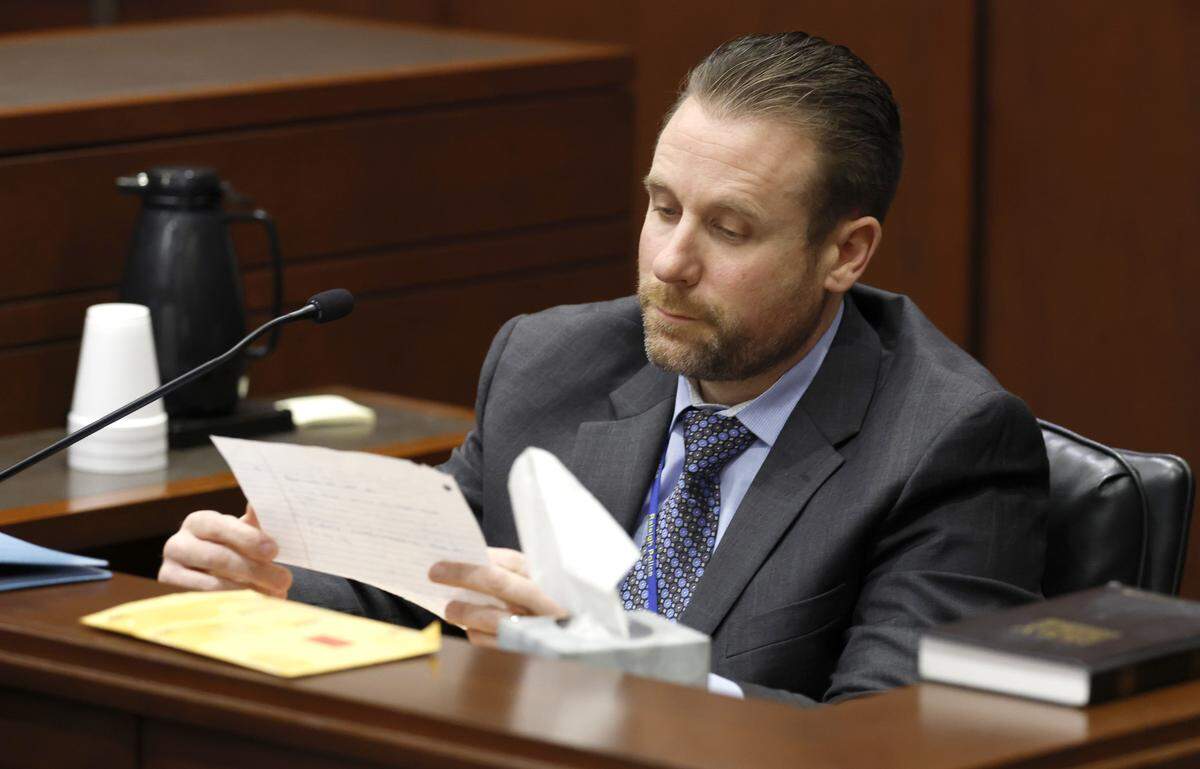 Raleigh Police Detective William Tripp looks over a note written by Austin Thompson during the sentencing hearing for Thompson Thursday, Feb. 5, 2026. Thompson previously pleaded guilty in the 2022 Hedingham neighborhood mass shooting that killed five people.