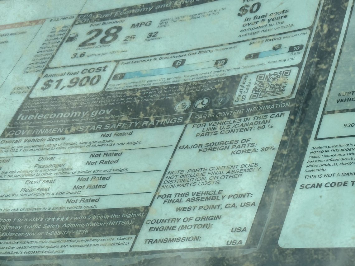 A vehicle sticker displays parts content information at Fred Anderson Kia of Raleigh on March 31, 2025.