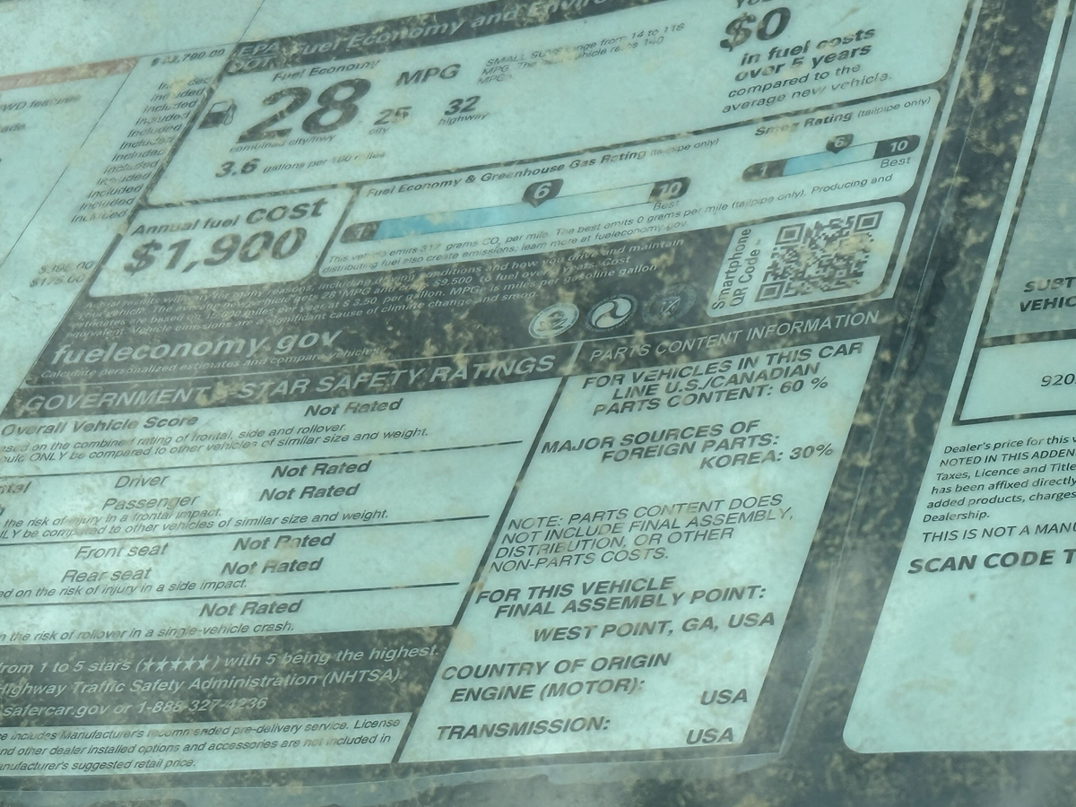 A vehicle sticker displays parts content information at Fred Anderson Kia of Raleigh on March 31, 2025.