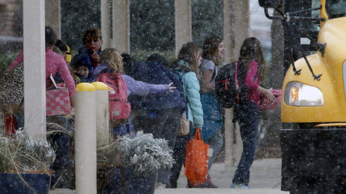 A fine powdery snow began falling around 12:30 p.m. on Feb. 12, 2016, as students began boarding their buses for a previously scheduled early release day at Cary Elementary School.  Wake County is eliminating early release days starting in the 2019-20 school year.