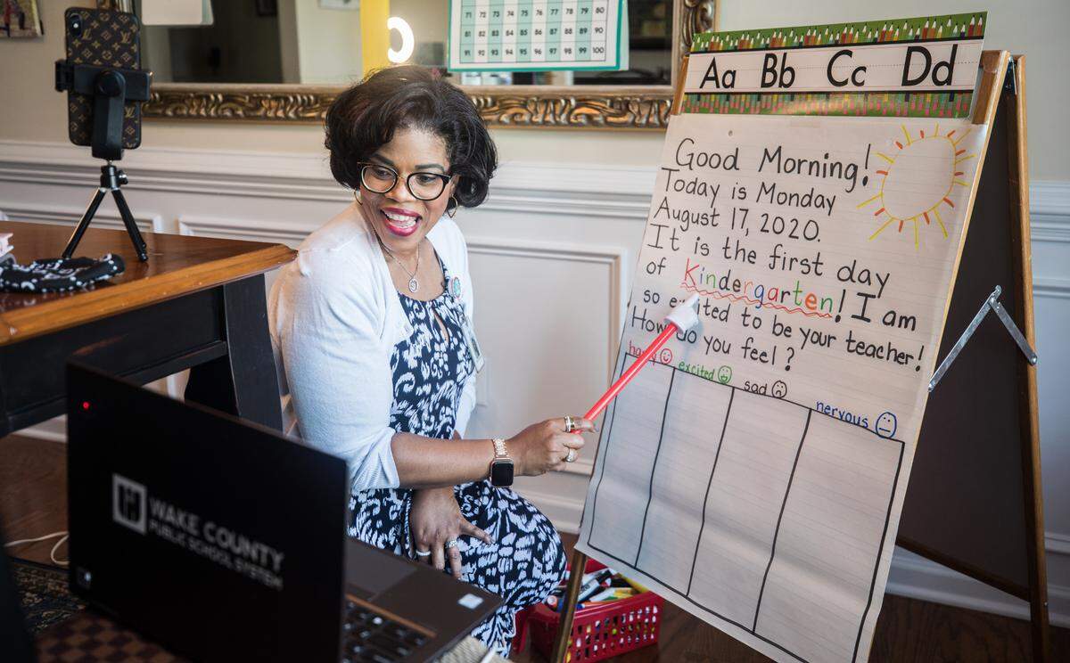 Shilo DeShield, a kindergarten teacher at Southeast Raleigh Elementary School, shows her students a welcome poster at her home in Knightdale, N.C. during their first virtual lesson of the school year on Monday, Aug. 17, 2020.