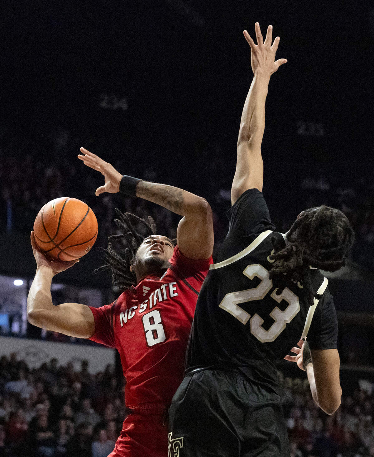 N.C. State’s Jayden Taylor shoots over Wake Forest’s Hunter Sallis during the first half of the Wolfpack’s 77-59 loss on Saturday, Jan. 4, 2025, at Lawrence Joel Veterans Memorial Coliseum in Winston-Salem, N.C.
