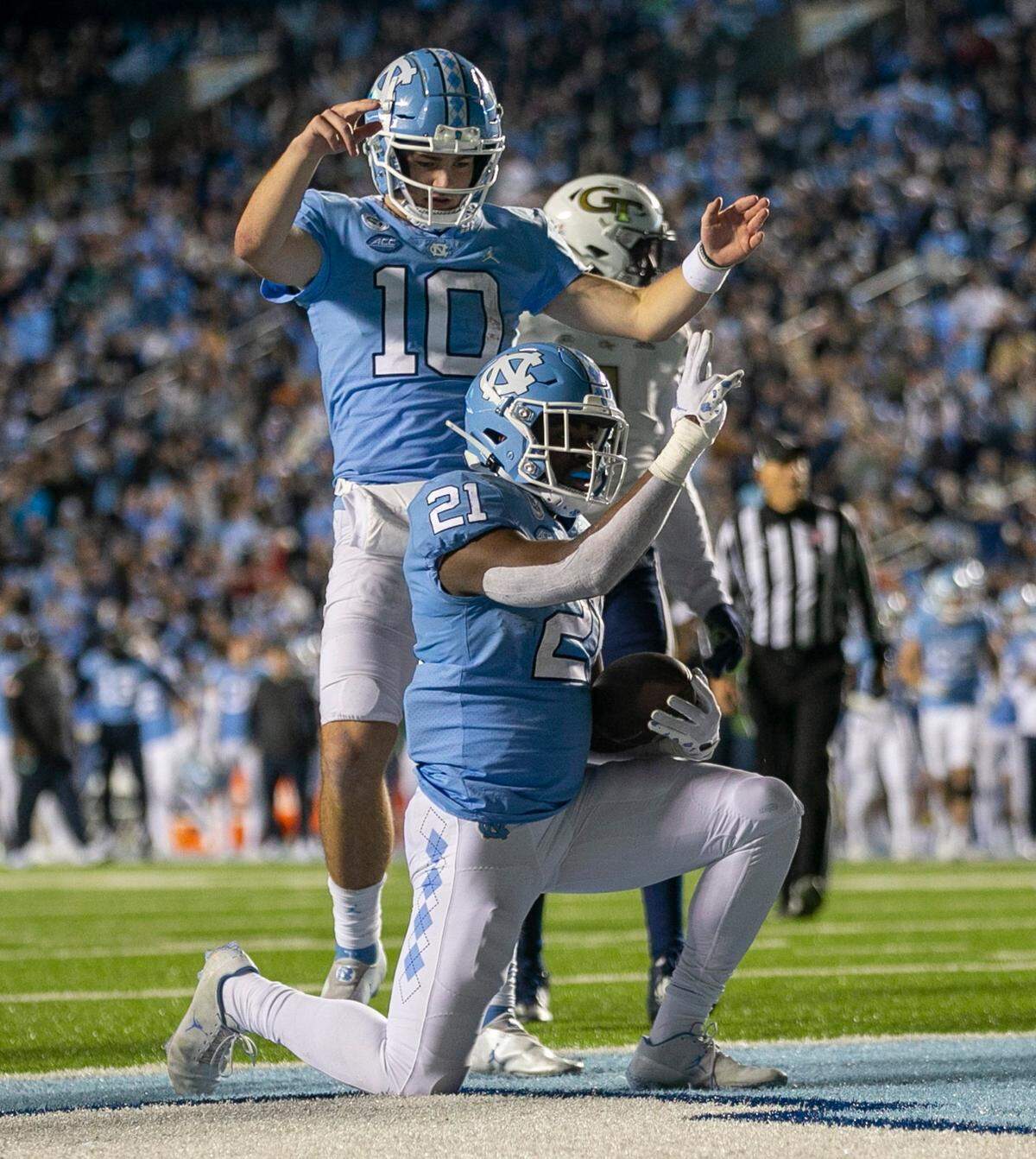 North Carolina’s Elijah Green (21) and quarterback Drake Maye react after a 1-yards run for a touchdown in the second quarter against Georgia Tech’s on Saturday, November 19, 2022 at Kenan Stadium in Chapel Hill, N.C.